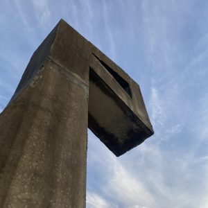 

Angular concrete structure against a blue sky with wispy clouds.