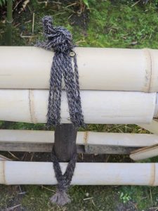 Close-up of a tied rope joint on a bamboo fence post. Captured at Portland Japanese Garden.