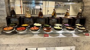 A salad bar featuring a variety of fresh vegetables and toppings.