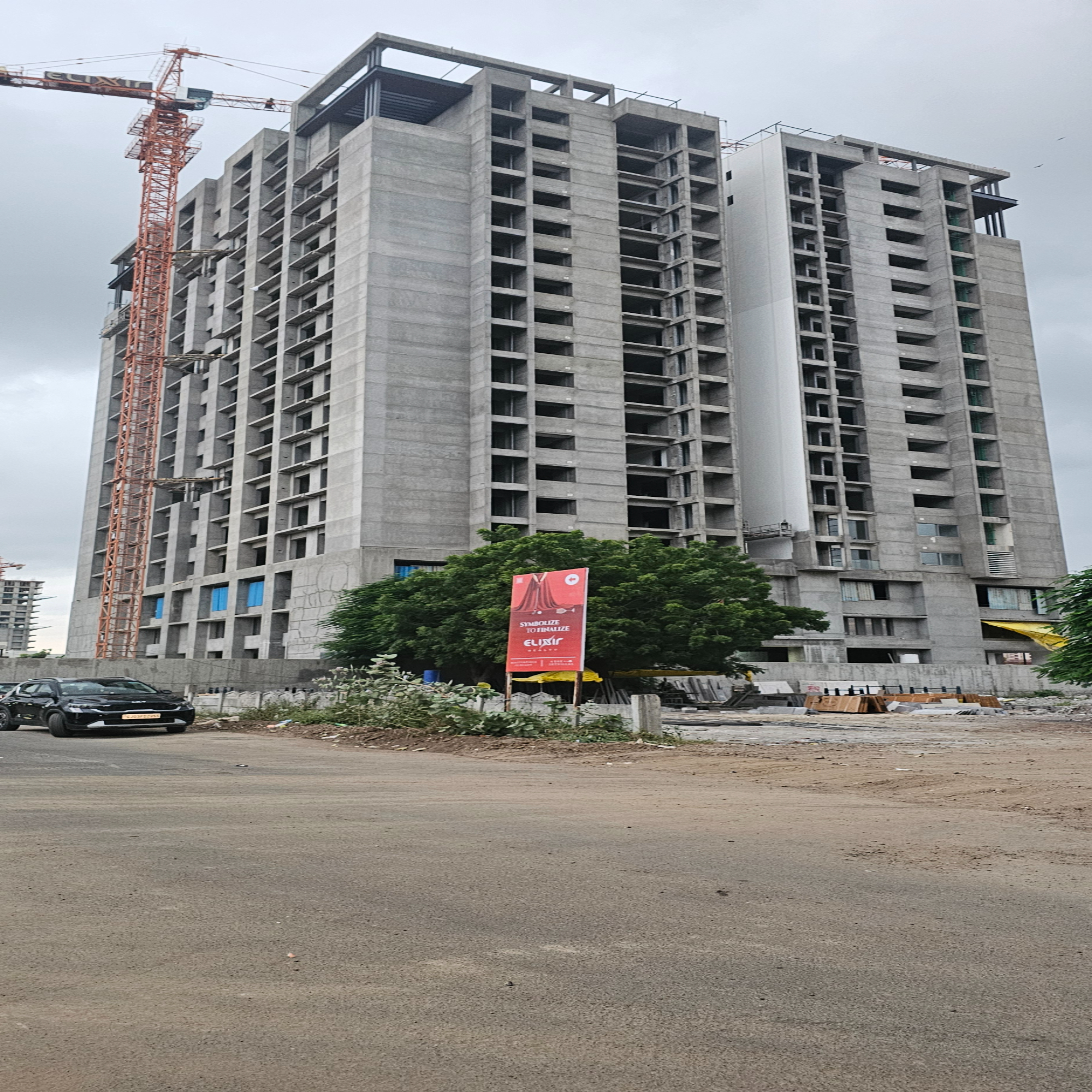 A modern real estate multi-story building in progress, showcasing construction work and structural development.