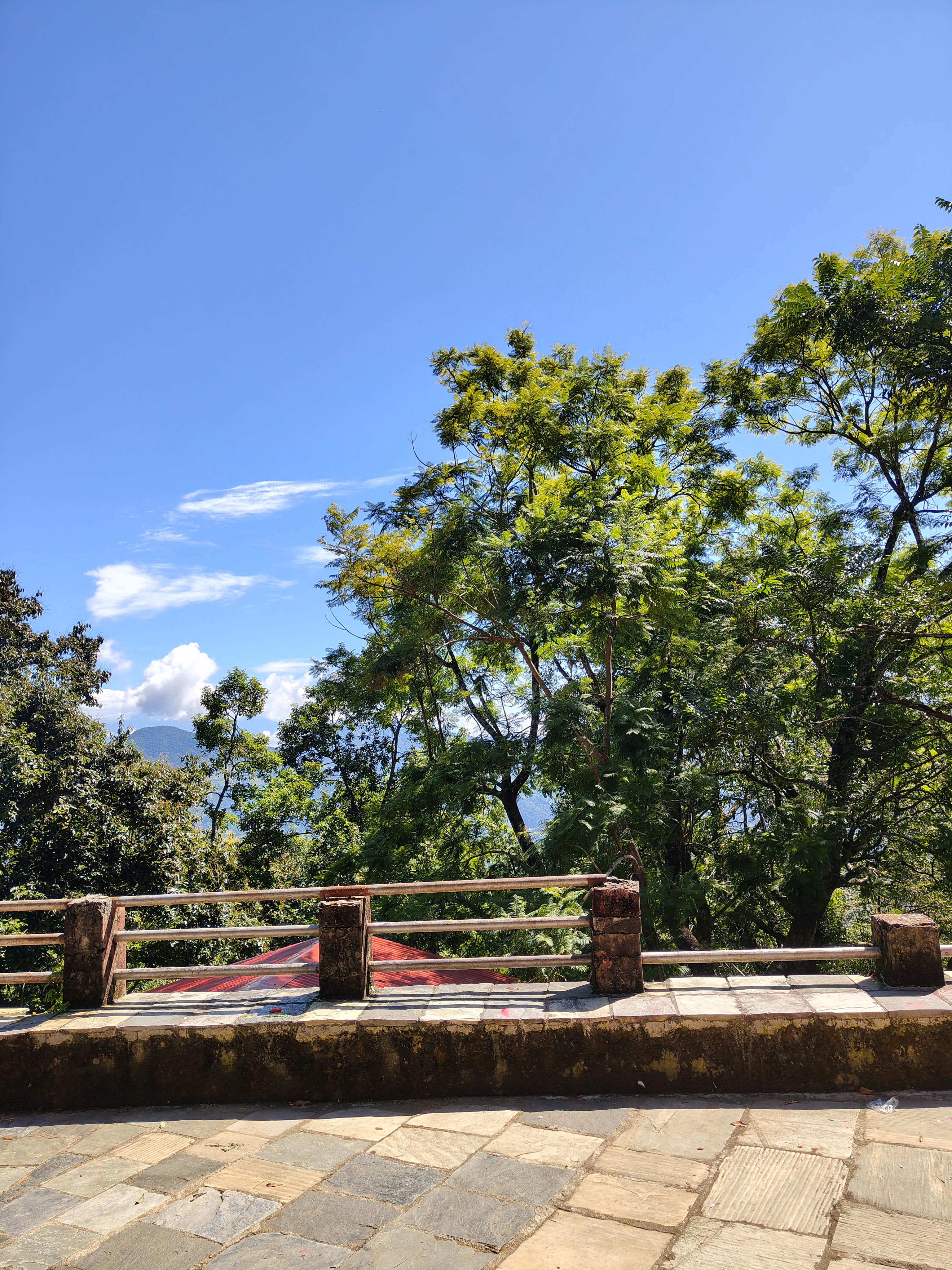 A scenic view featuring a clear blue sky with a few scattered clouds.