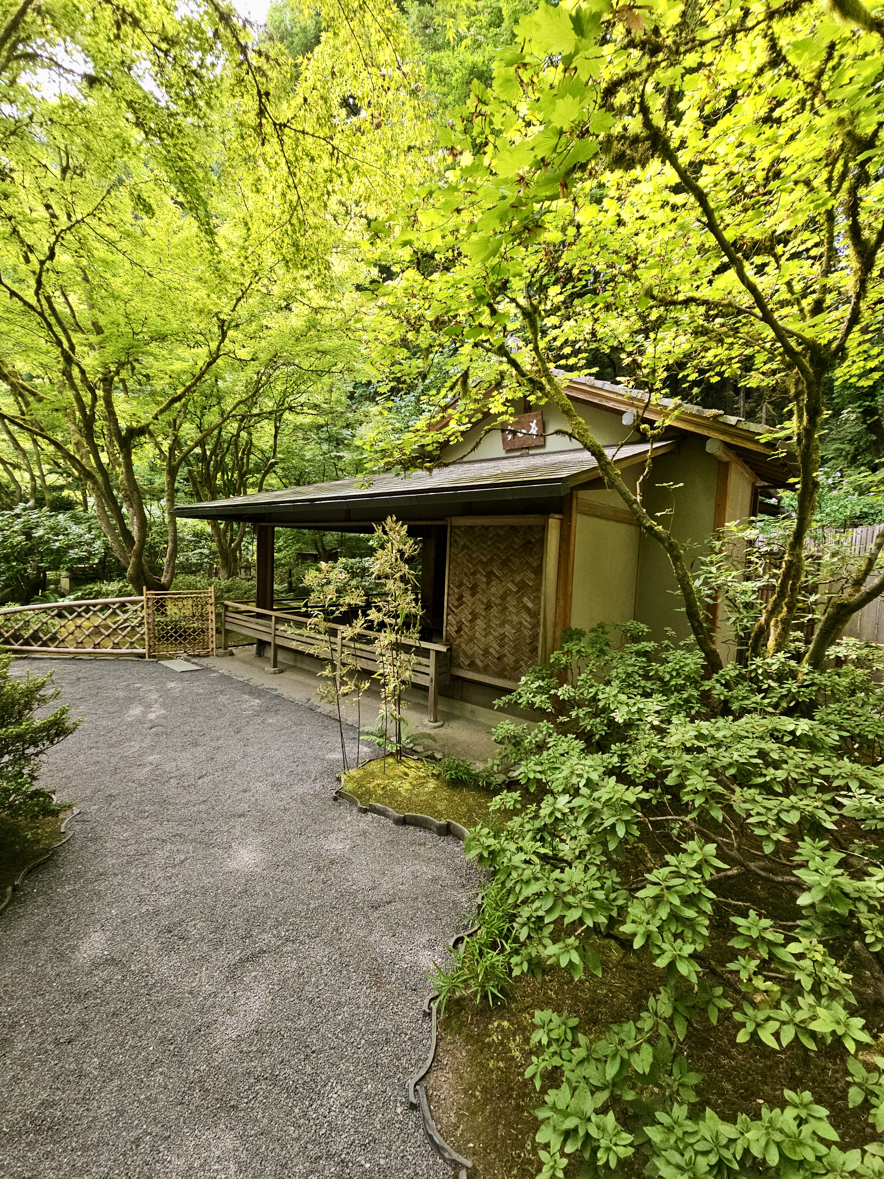 A quiet tea house surrounded by trees, moss, and gravel paths at Portland Japanese Garden.