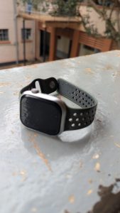 A smartwatch rests on the balcony with a nicely blurred background