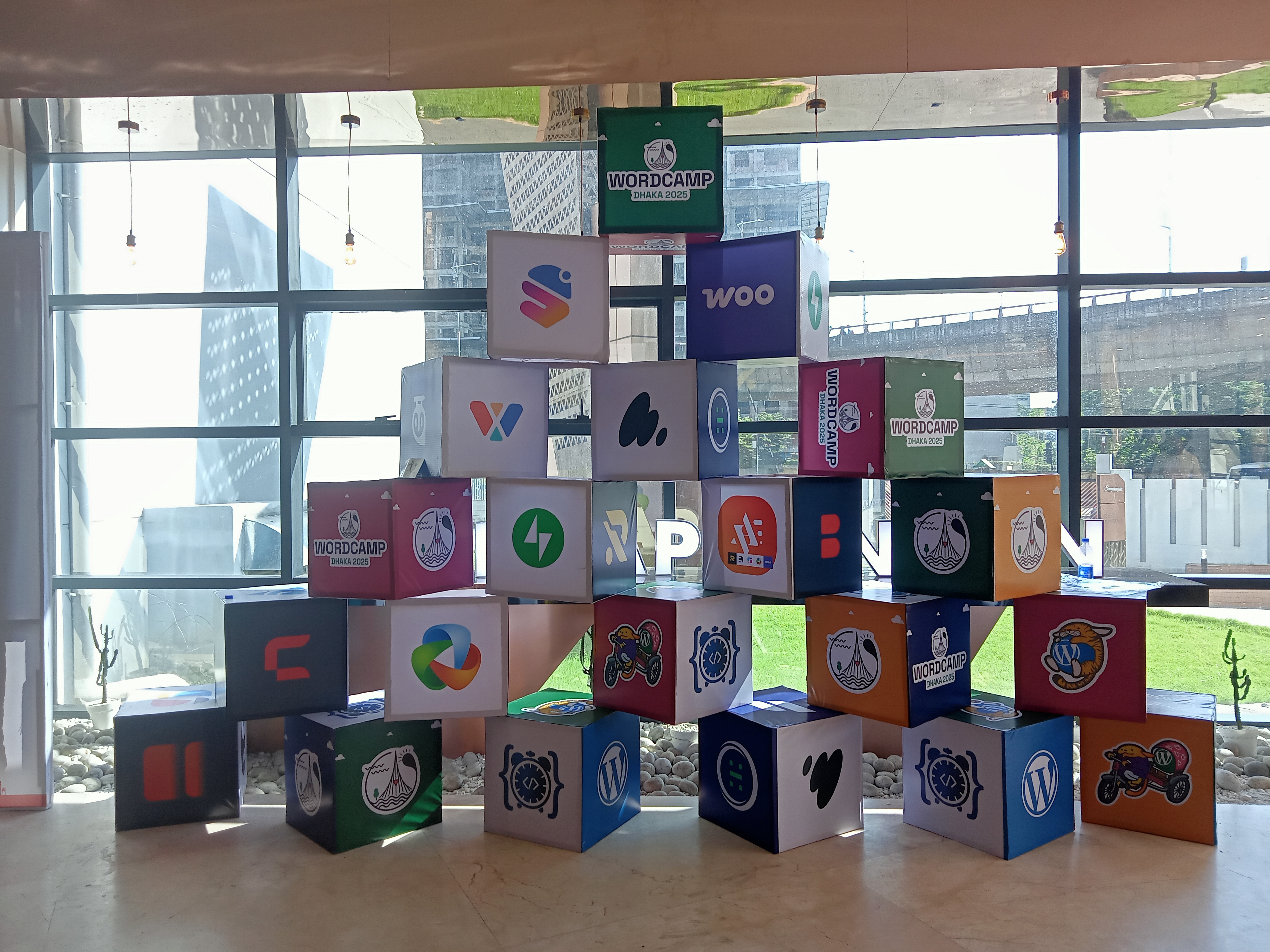 Stacked blocks showing the logos for sponsors of WordCamp Dhaka 2025