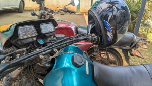 dashboard and handlebars of a motorcycle with a helmet on top