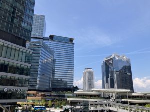 Modern buildings rising north of Osaka Station in Japan, connected by a pedestrian deck
