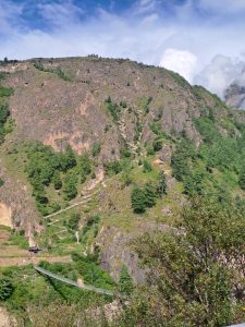 A scenic mountainous landscape featuring steep, rocky cliffs adorned with patches of greenery.