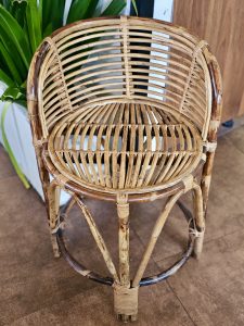 A handmade bamboo wicker chair with a curved backrest and round seat. The natural tones and simple craftsmanship make it an ideal choice for traditional interiors. Photographed near Fort Kochi Beach, Kerala. 