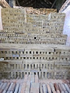 Clay bricks stacked inside a drying chamber. Photo taken in Perumanna, Kozhikode, Kerala, showing a step before the firing process in traditional kilns. 