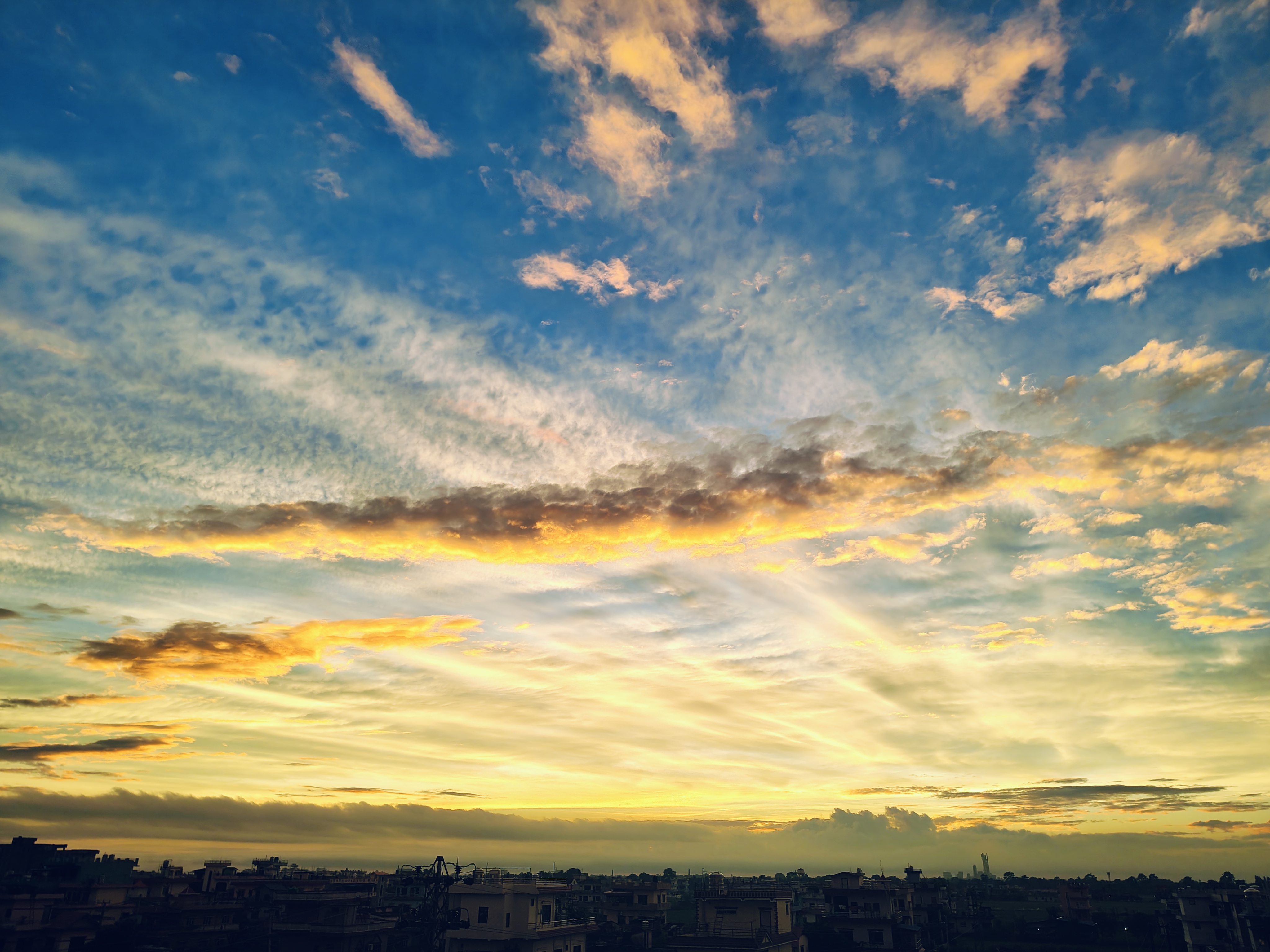 A vibrant sunset sky filled with a mix of blue, orange, and yellow hues