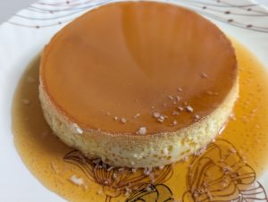 A close-up of homemade caramel pudding served on a white plate