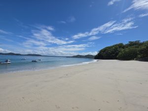 This is a picture of Penca Beach, Guanacaste, Costa Rica. There, we can see the beauty of Costa Rican beaches. Additionally, the impact of gentrification is notable, as this beach is not easily accessible to Costa Rican people. Although it is a public beach, it is surrounded by private constructions. 