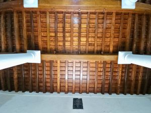 Polished wooden ceiling with white columns inside St. Francis Church in Fort Kochi, Kochi. A showcase of traditional Kerala craftsmanship and colonial elegance. 
