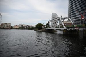 A view of a river with a bridge crossing over it. 