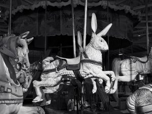 An antique carousel featuring a ride-on wooden rabbit.
