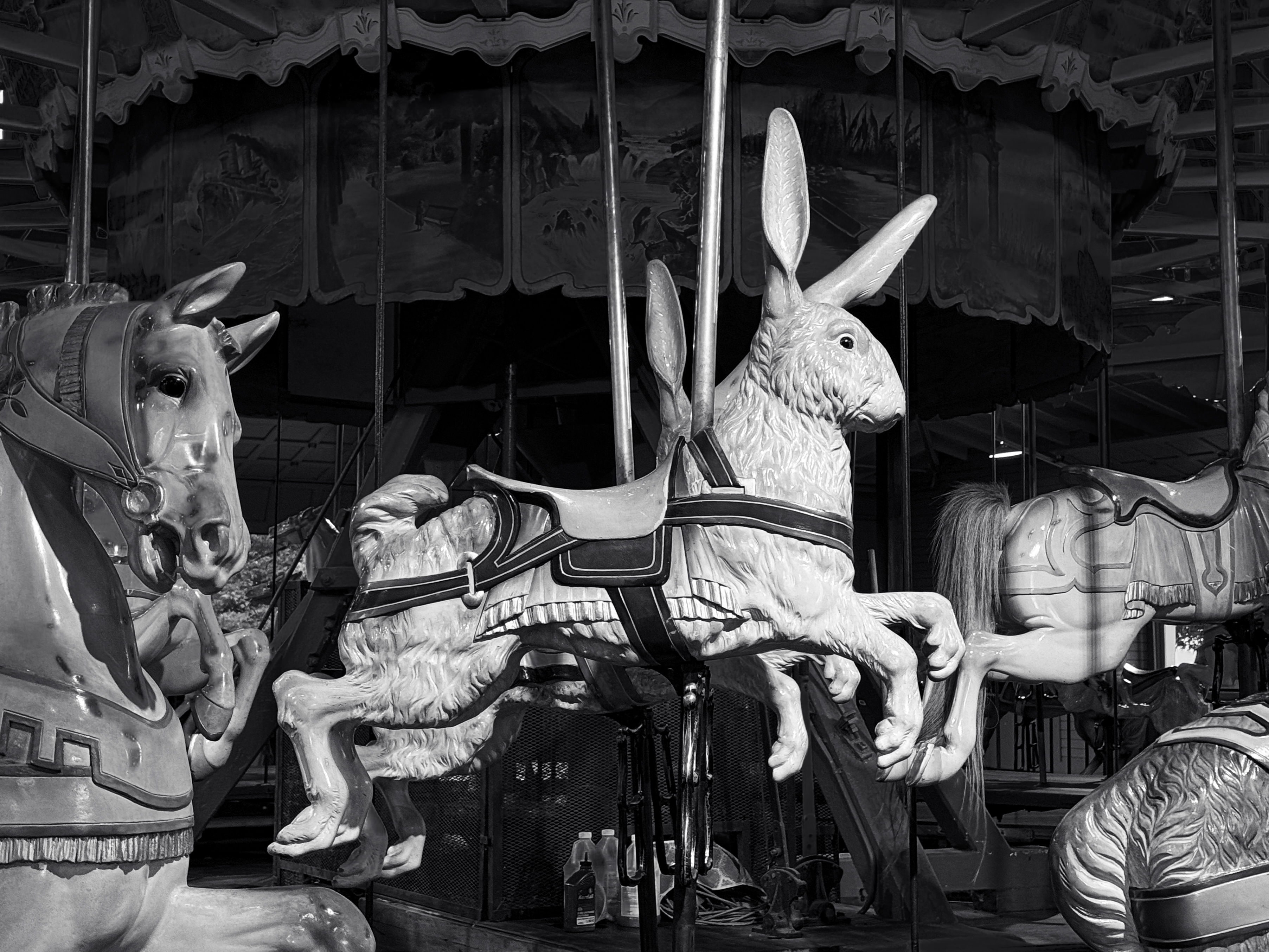 An antique carousel featuring a ride-on wooden rabbit.