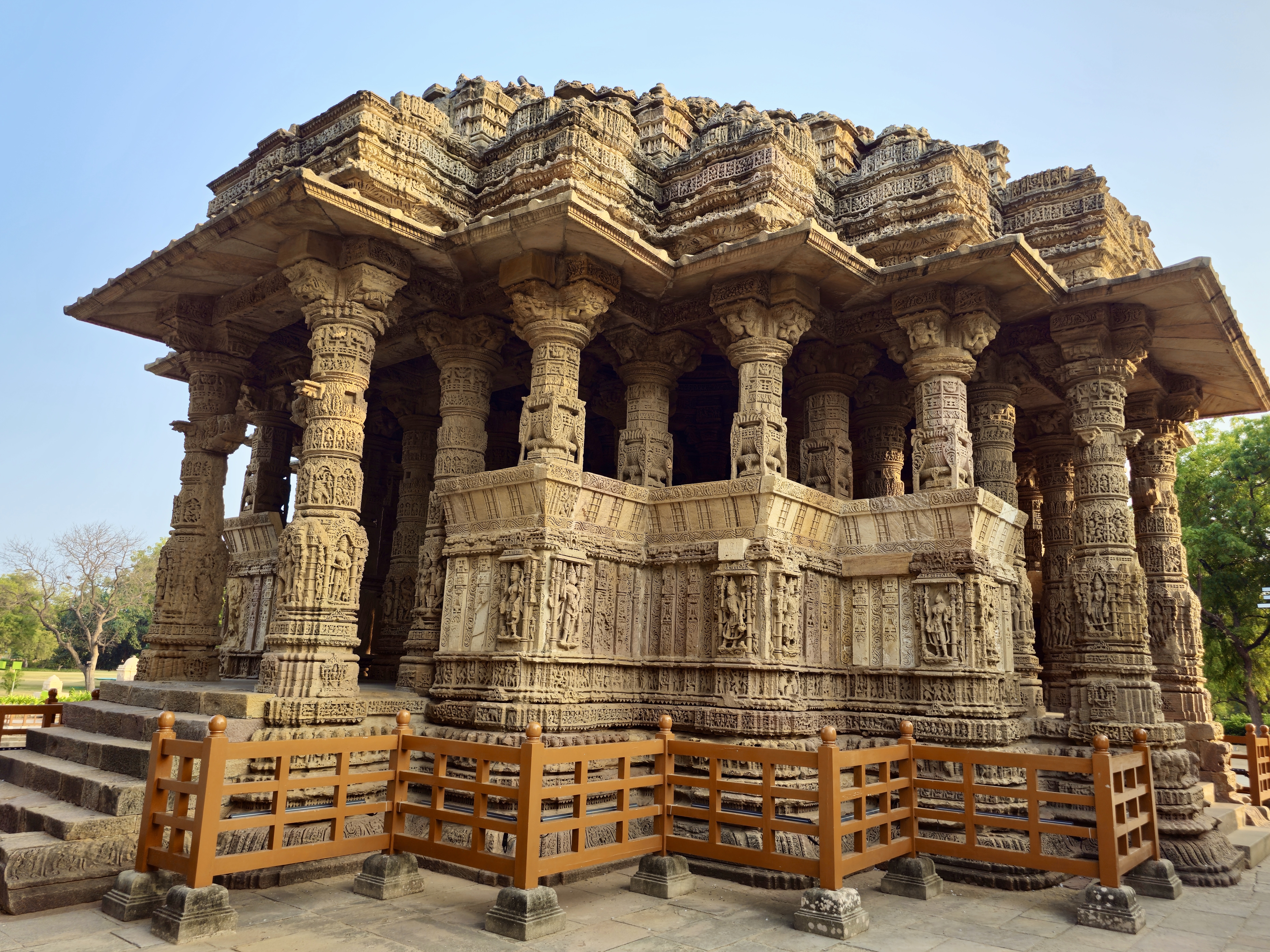 Intricately carved sandstone pillars and outer walls of the Sun Temple at Modhera, Gujarat. This historic temple, built in the 11th century, showcases stunning architecture dedicated to the solar deity Surya.