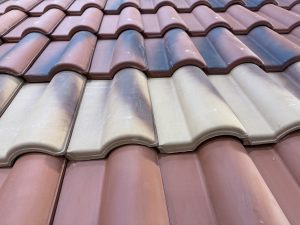 Close-up view of ceramic roof tiles with a glossy gradient finish, arranged in a wave pattern, captured at Calicut Trade Centre, Kozhikode. 