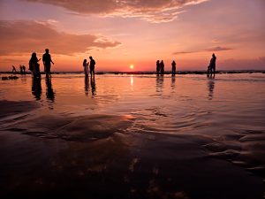 People are enjoying the sunset at Cox’s Bazar Inani Sea Beach.