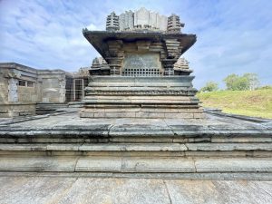A rear view of the sanctum at Lakshmi Narasimha Temple, Nuggehalli, Hassan. The layered stone base and clean lines highlight Hoysala architecture in soft sunlight. 