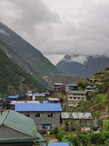 A scenic view of a mountainous landscape featuring a small village nestled in a valley. 
