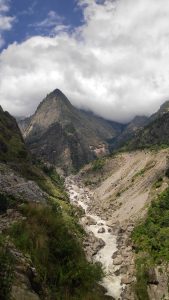 A breathtaking mountainous landscape with steep, rocky slopes and lush greenery.