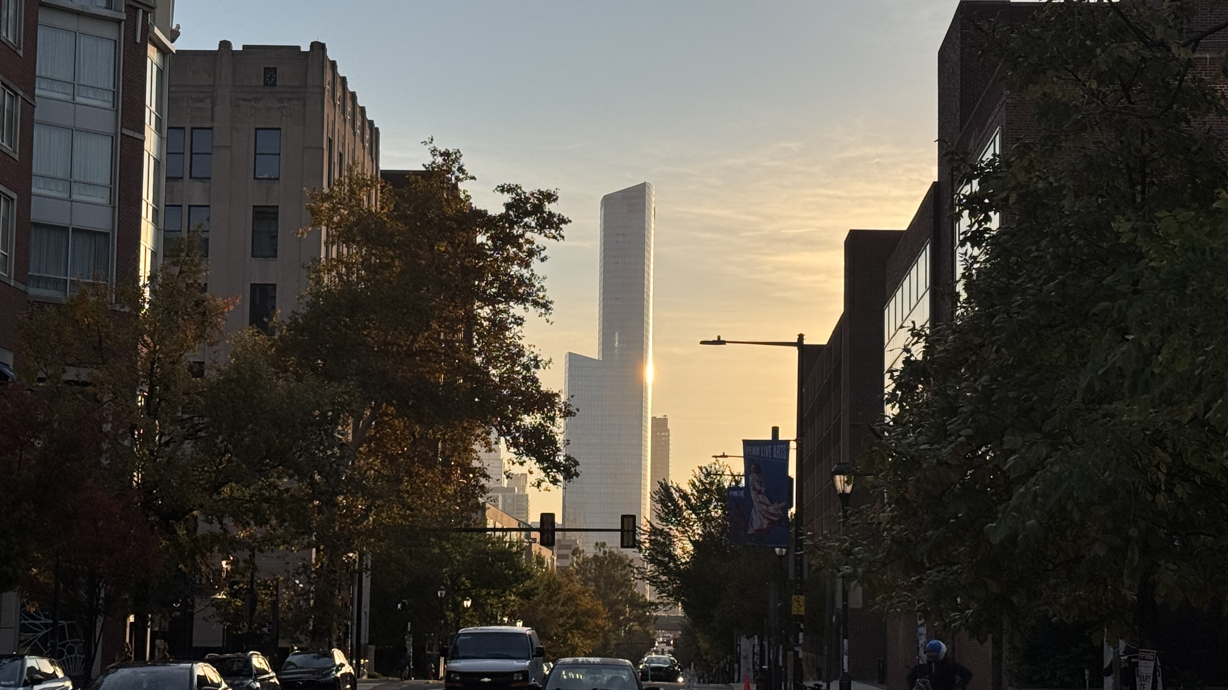 Looking east down Walnut Street at A tall sky scraper in Philadelphia. It's at sunrise.