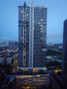 The image features a tall building characterized by numerous windows. It is located in an urban environment, contributing to the cityscape of a metropolitan area. This skyscraper serves mixed purposes, likely including commercial and residential spaces. It stands prominently against the skyline of the downtown area.
