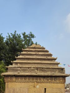 Intricate stepped roof of the Adalaj Stepwell (Gandhinagar, Gujarat), showcasing lattice stonework and traditional Gujarati architecture against a clear sky.  