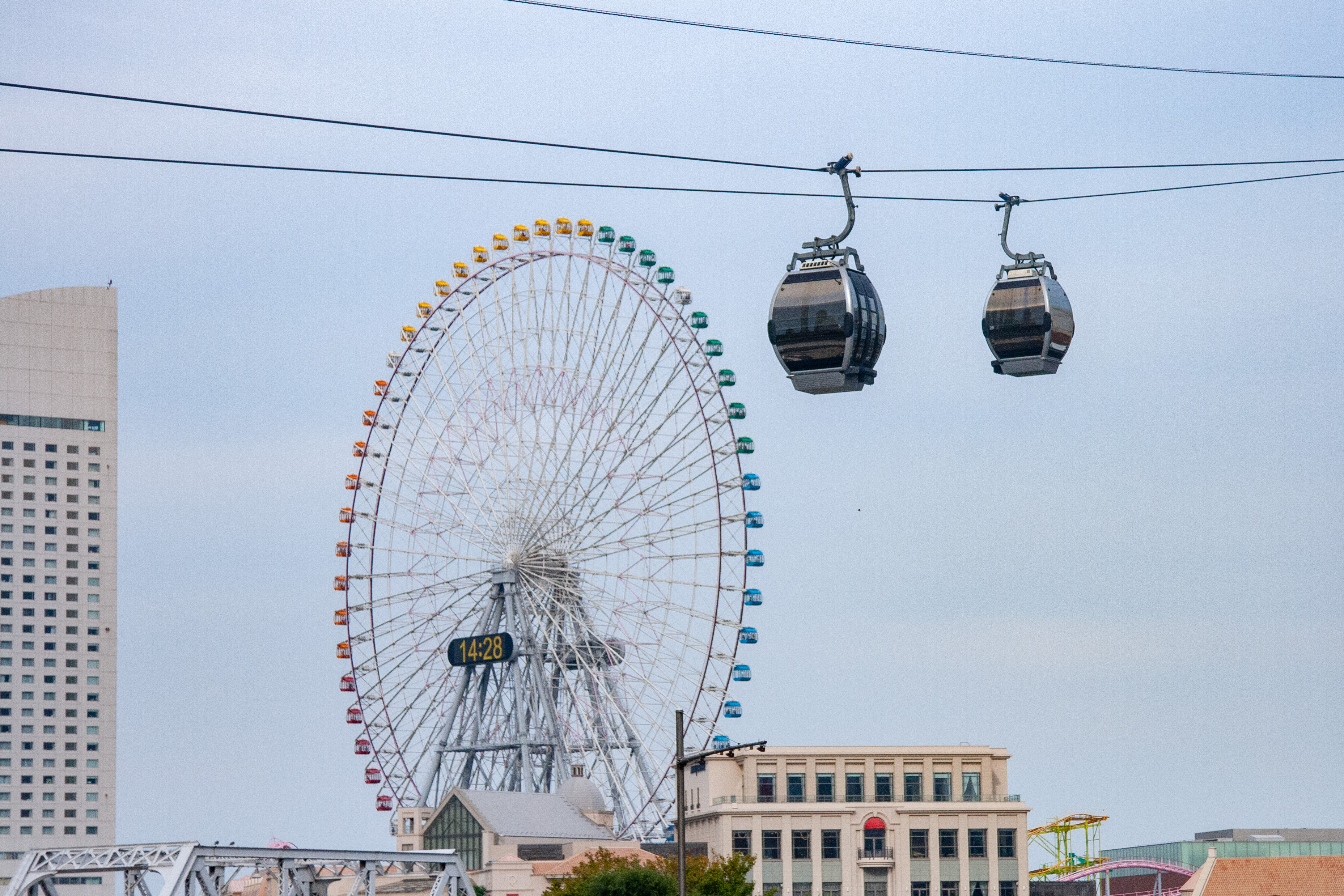 A giant Ferris wheel at Yokohama Pier and a ropeway spanning the sea