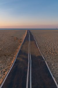 A narrow path leads across the sand to the sea – a quiet morning at Gruissan beach.
