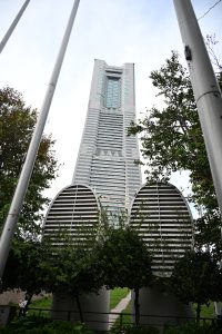 

A low-angle view of Yokohama Landmark Tower set against a cloudy sky.
