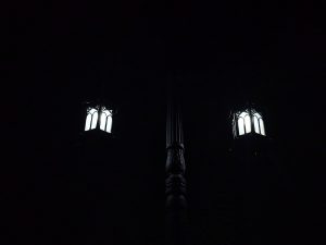 A classic-style twin streetlamp glows quietly in the night sky near St. George's Forane Church, Edappally, Kochi. The intricate metal design adds a peaceful charm to the surroundings. Captured in complete darkness. 