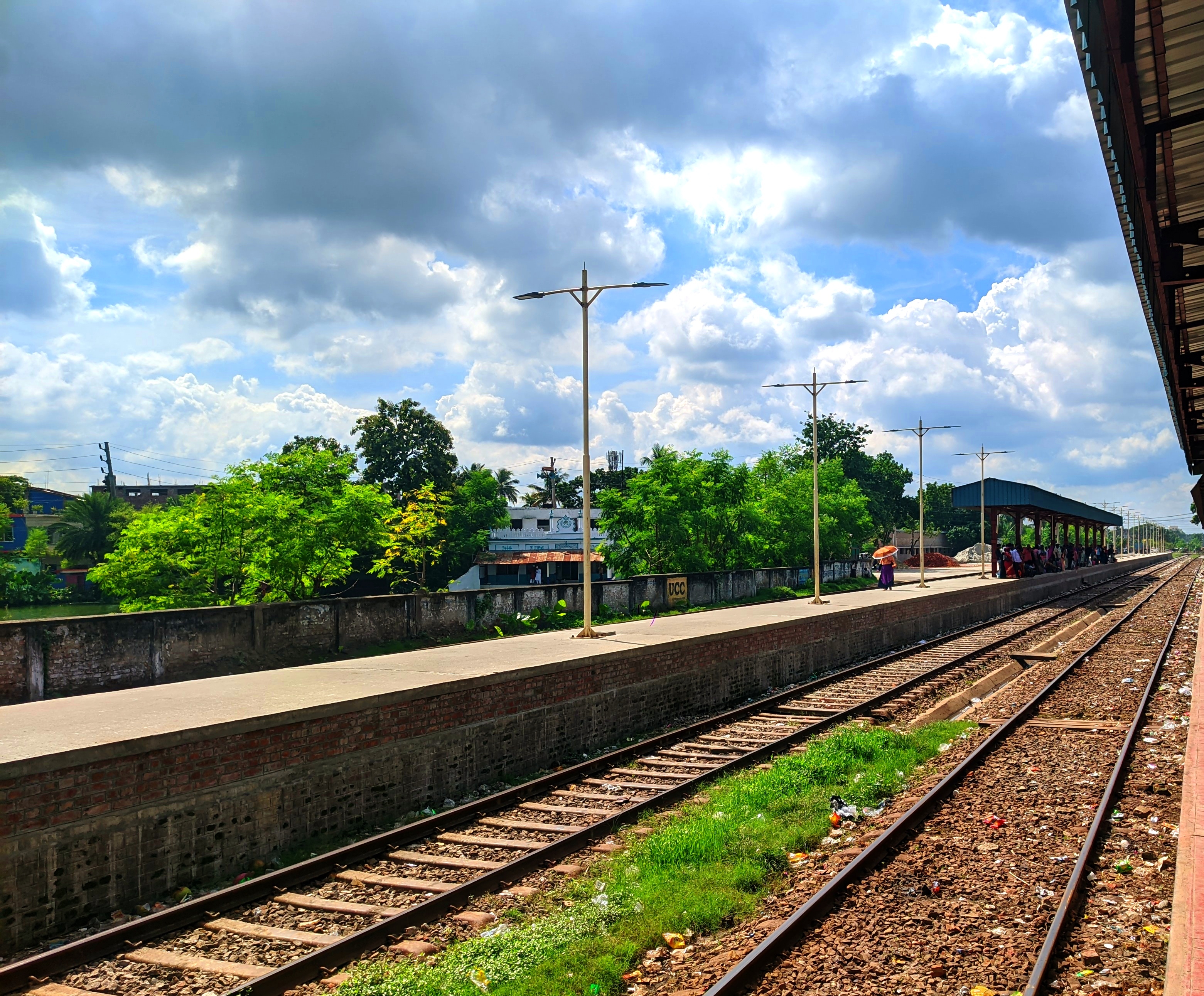 A railway track in Bangladesh. People are waiting for their train to arrive. The silence here is loud with a thousand untold departures and arrivals.