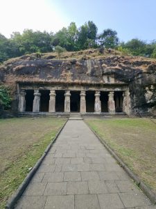 View of ancient stone-pillared cave temple on Elephanta Island, Mumbai, Maharashtra. The pathway leads to the historical entrance.