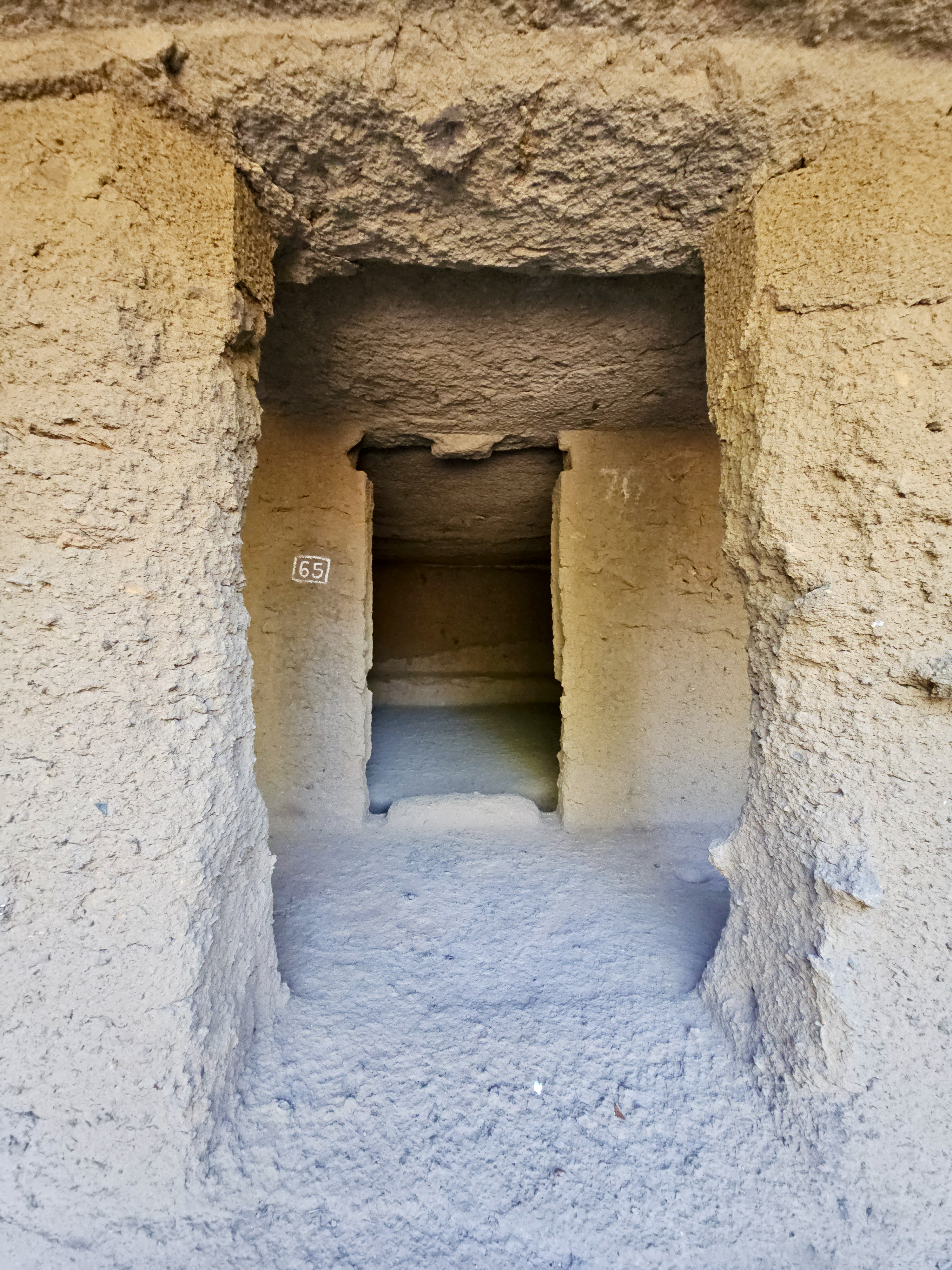 A narrow stone passage inside Cave 65 at Kanheri Caves, Borivali, Mumbai. The rough textures and simple layout reflect the early Buddhist monastic design.