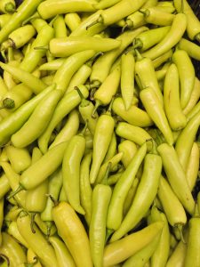 Fresh yellow chilies stacked together, showing smooth skin and vibrant colour at a hypermarket in Kozhikode, Kerala. 