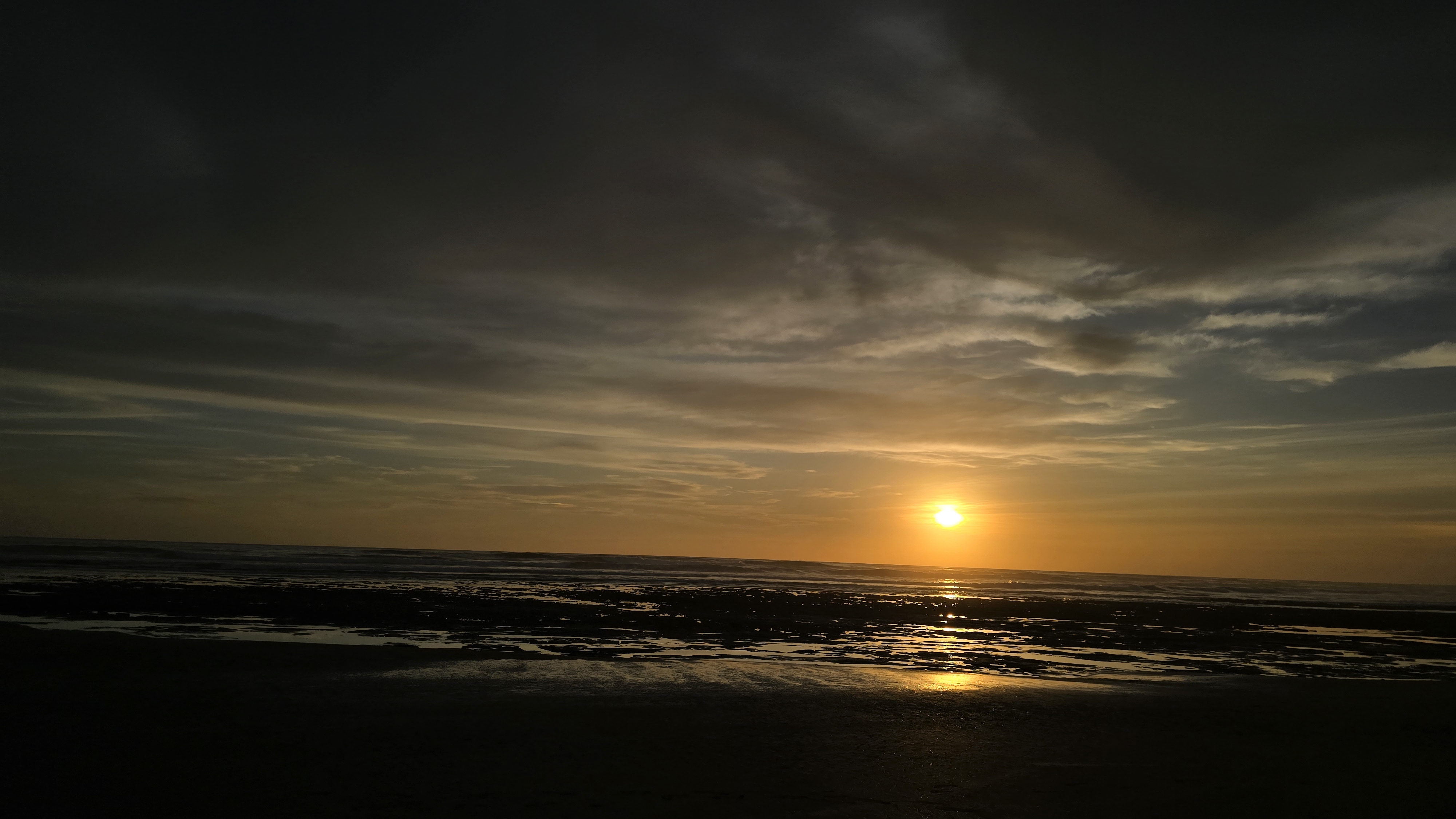 A golden sunset glows over the ocean at Masachapa Beach, Nicaragua.