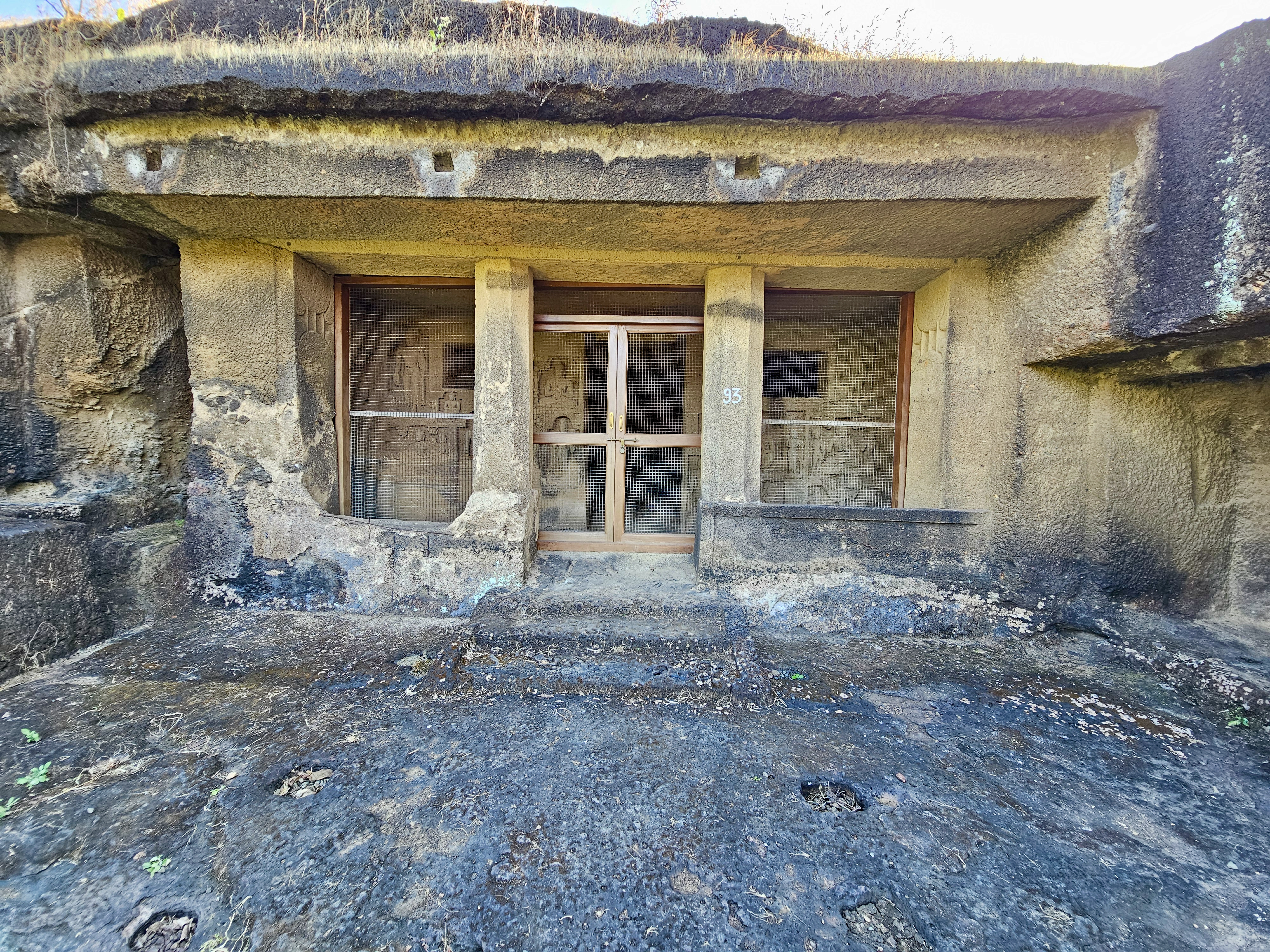 A front view of Cave 95 at Kanheri Caves, Mumbai. The rock-cut doorway and carved walls show the ancient craftsmanship of this historic Buddhist site. 
