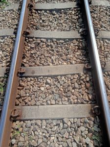 Railway Track view with small stones placed all over the base of the track, at Kawtoli, Brahmanbaria, Bangladesh.