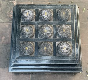 

A symbolic sculpture of gods on a dark stone platform with ornate golden details.