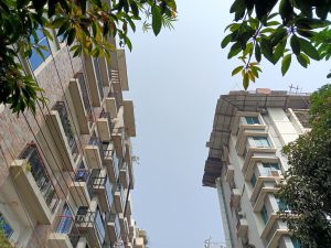 A view looking up between two buildings, showcasing their facades. 