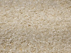 Short white rice grains are displayed in bulk at a hypermarket in Kozhikode. The smooth, polished grains are a common rice variety used in Kerala homes for breakfasts like dosa and idli.