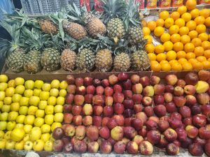 A vibrant display of fresh fruits arranged in rows.