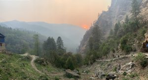 A beautiful scenic view of the green hilly areas, man walking road, and few pedestrians walking, sunset, nature.