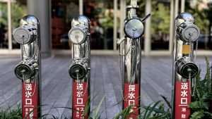 Fire hydrants with Japanese writing on a street in Umeda, Osaka.
