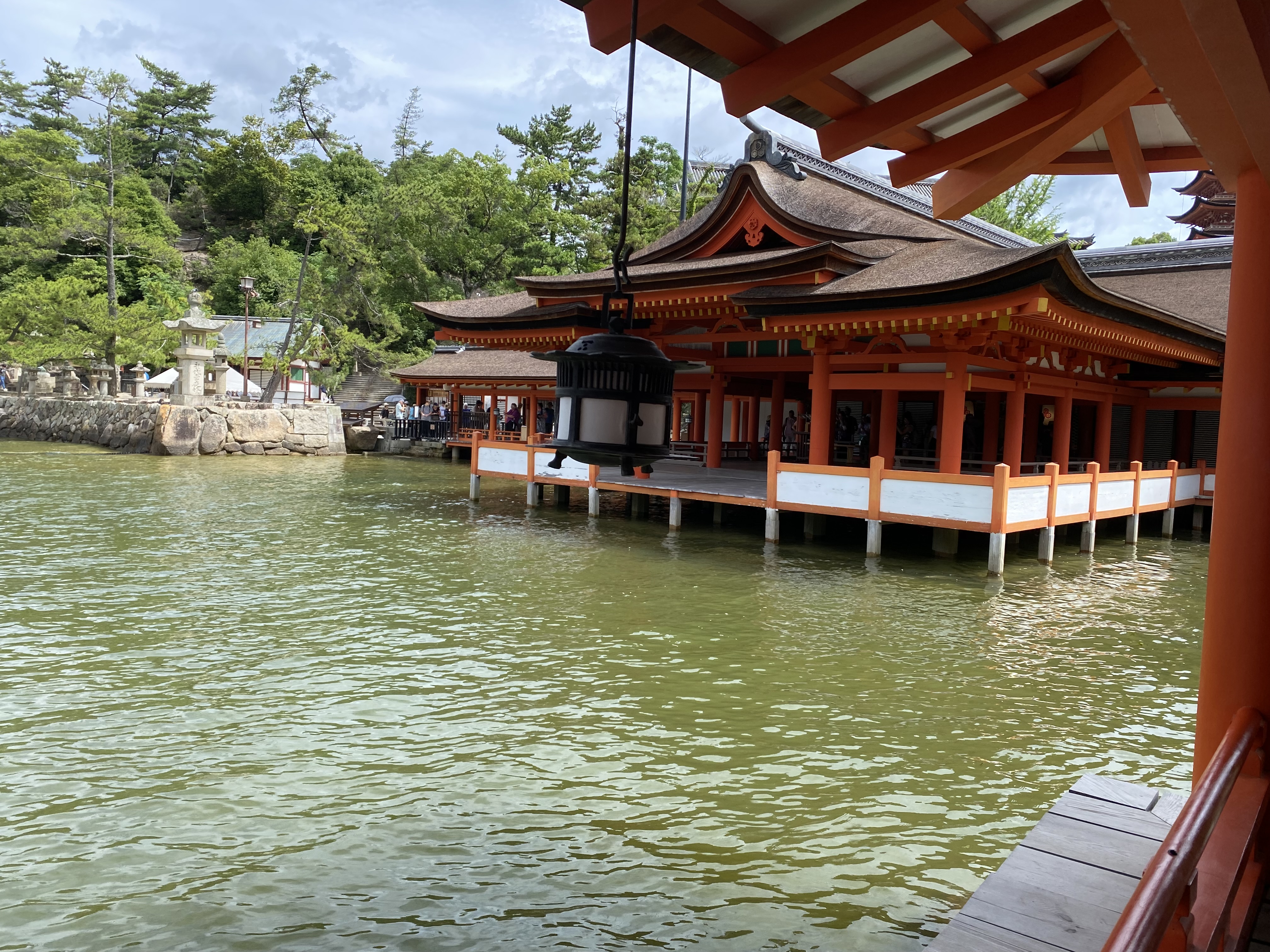 A picture of a Maroudou Shrine at Itsukushima Shrine on Miyajima Island in Hiroshima, Japan. Photographed from the corridor at high tide.