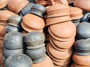 Stacks of traditional terracotta and blackened clay pots in Kozhikode, Kerala. The earthy textures and colours reflect the region’s rich pottery craftsmanship and everyday heritage. 