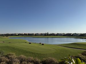 Golf field view in Marassi with houses on the other side and a pond in between the green field, Egypt.