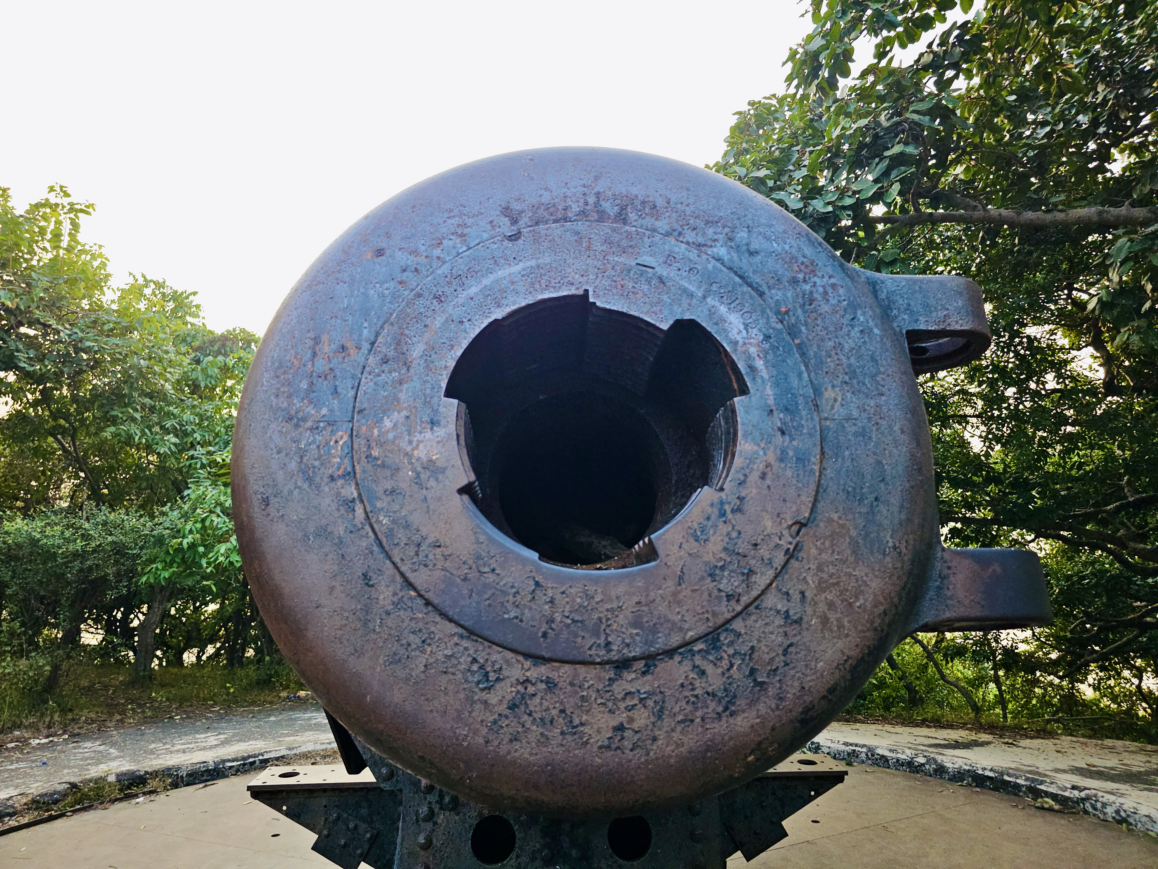 A close-up of the historic cannon at the Elephanta Caves in Mumbai. The worn metal surface and the broken inner parts reveal its age and the long history behind this structure. 